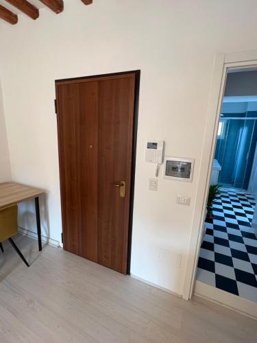 a wooden door in a room with a tile floor at Charming Navona in Rome