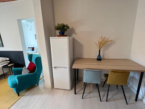a room with a table and a refrigerator and chairs at Charming Navona in Rome