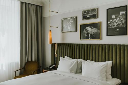 a hotel room with a bed and a window at Hotel Saski Krakow Curio Collection by Hilton in Kraków