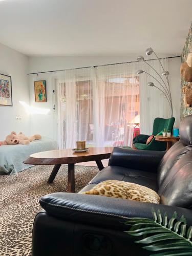 a living room with a couch and a table at LOU PANTAI in Levens