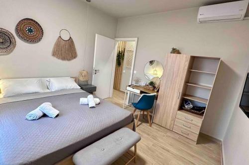 a bedroom with a bed and a desk and a chair at Boho Nomad Seaview Detached House in Análipsis