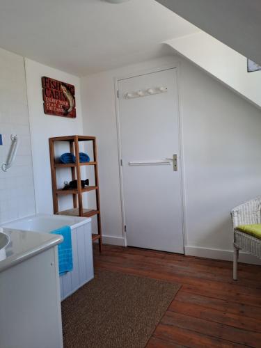 a kitchen with a white door and a shelf at Chambres Dhôtes Numéro 1 in Châteaulin
