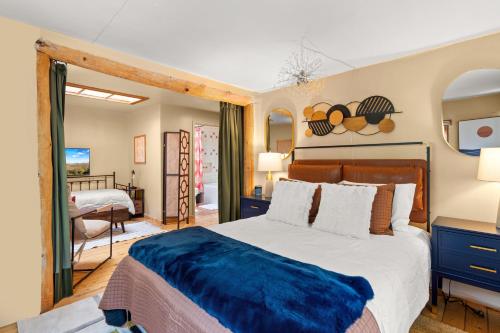 a bedroom with a large bed with a blue blanket at Adorable Home Centrally Located! in Santa Fe