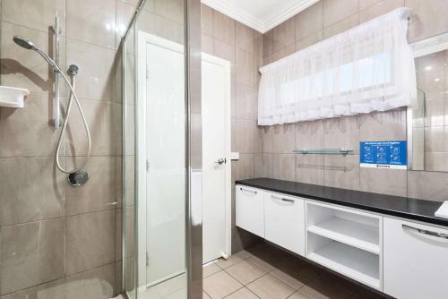 a bathroom with a shower and a sink at Comfort Inn Deakin Palms in Mildura