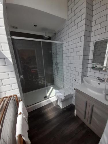 a bathroom with a shower and a sink at Potbank in Stoke on Trent