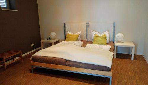 a bedroom with a bed with yellow pillows at Ferienwohnung Großer Onkel Nr 2 in Maasholm