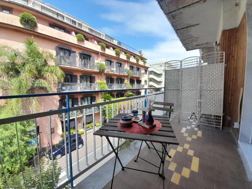 a balcony with a table with vases on it at ARIEL ROOMS in Sorrento