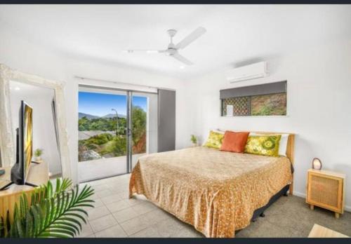 um quarto com uma cama e uma grande janela em Tranquil paradise - whole home - with views! King and Queen beds em Woree