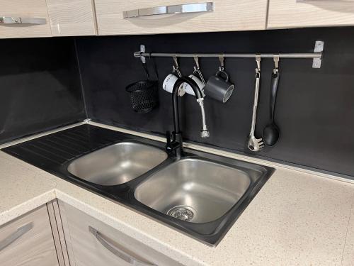 a stainless steel sink in a kitchen with utensils at Charming Navona in Rome