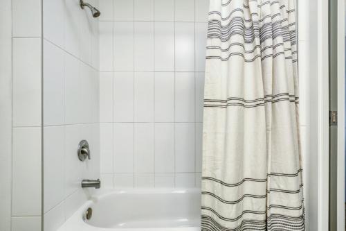 a bathroom with a shower curtain and a sink at Ballard Studio w Rooftop BBQ nr dining SEA-175 in Seattle