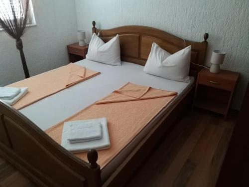 a large bed with a plate of food on it at Apartman Zahira in Karlobag
