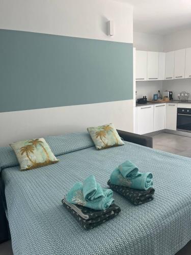 a bedroom with a bed with towels on it at "La Terrazza di Via Roma" Delta del Po - Private Parking in Porto Viro