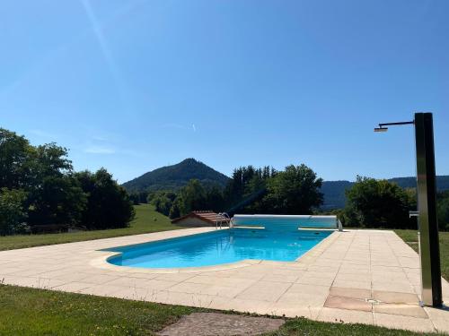 a swimming pool in a yard with a street light at Villa Le Chant des Sapins - Tennis, Pool, Golf in Le Saulcy
