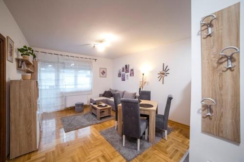 a living room with a couch and a table at Lux Apartmani Rakić in Pirot