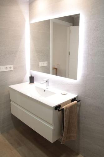a bathroom with a white sink and a mirror at Ca Lanosa in Alicante