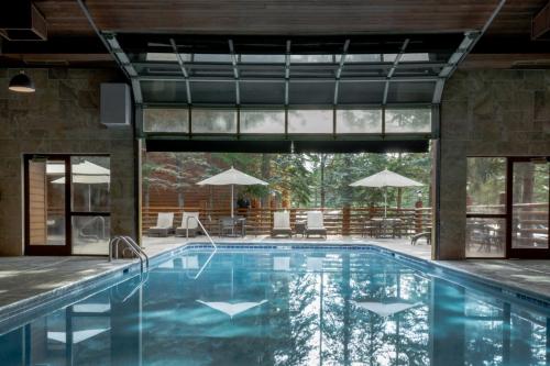 an indoor pool with a view of a house at The Lodge at Jackson Hole in Jackson