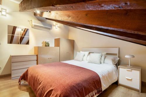 um quarto com uma cama grande e um cobertor vermelho em Victor Apartments Plaza España em Madri