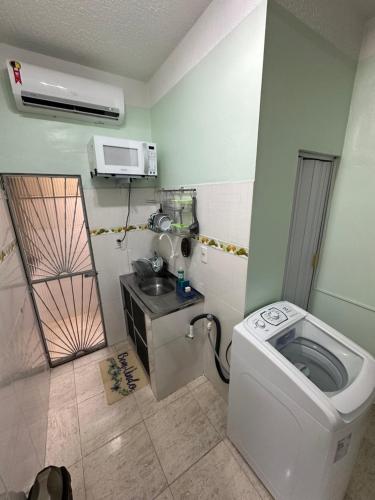 a small bathroom with a toilet and a sink at Apto mobiliado confortável 04 in Manaus