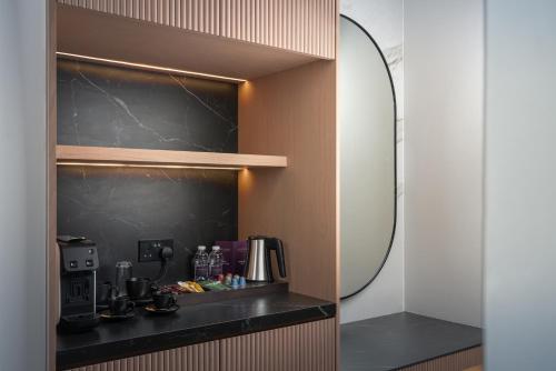 a room with a mirror and a coffee maker at JOUDYAN Red Sea Mall Jeddah By ELAF in Jeddah