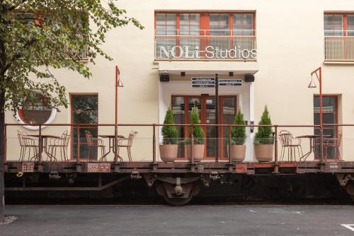 a building with chairs and tables in front of it at Noli Katajanokka II in Helsinki