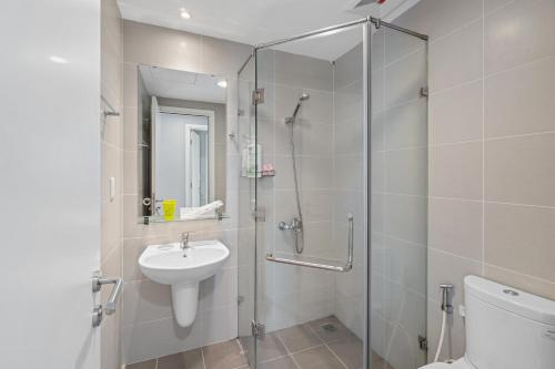 a bathroom with a shower and a sink and a toilet at Cozy 2 Bedroom Condo in Masteri Thao Dien, Fully Furnished With Full Amenities in Ho Chi Minh City