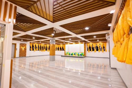 a large room with a large ceiling with yellow jerseys on the walls at Grand Mercy Hotel in Calbayog