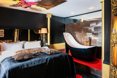 a bedroom with a bed and a chair at Bomans Hotell i Trosa in Trosa