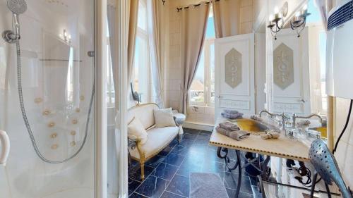 a bathroom with a shower and a sink and a tub at Château "Le Castel des Anges" in Wailly-Beaucamp