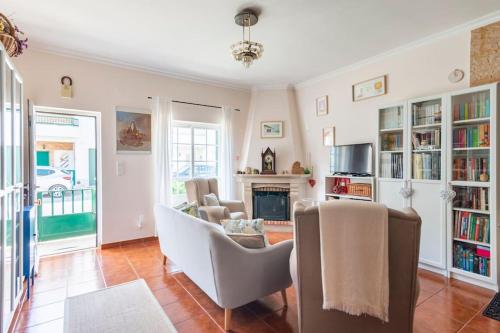 a living room with chairs and a fireplace at Suite Mendanha in Samora Correia