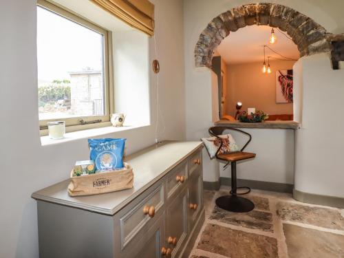 a kitchen with a counter and a window at The Cow Shed in Holmfirth