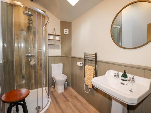 a bathroom with a shower and a sink and a toilet at The Hayloft in Holmfirth