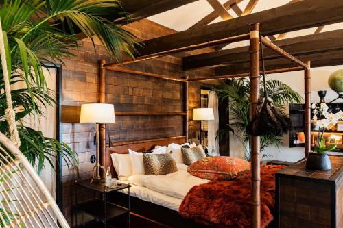 a bedroom with a canopy bed with pillows at Bomans Hotell i Trosa in Trosa