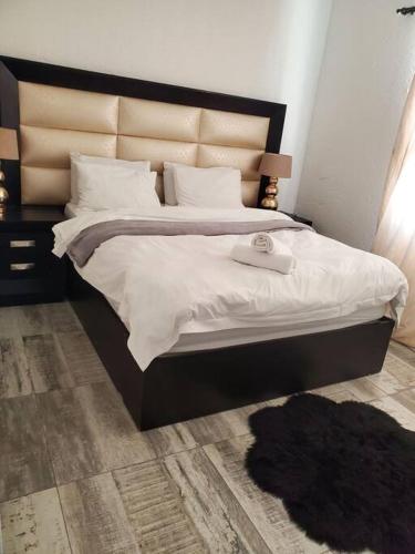 a bedroom with a large bed with white sheets at Lovely apartment Back-up power in Sandton