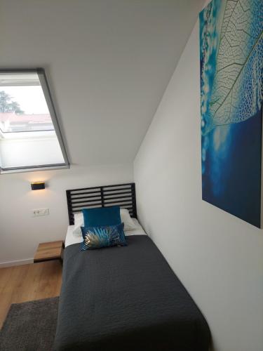 a bedroom with a bed with a large window at COMFORT Suites VELIKA GORICA in Velika Gorica