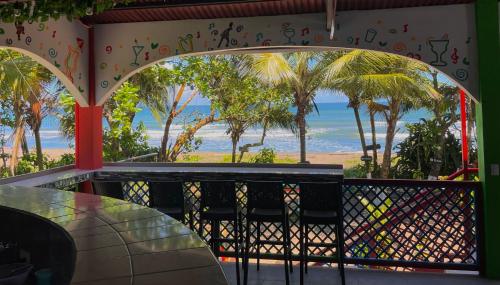 a view of the ocean from a restaurant with a table at Hotel El Icaco Tortuguero in Tortuguero