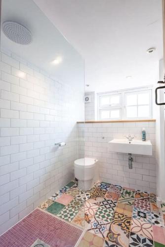 a bathroom with a toilet and a sink at Lilac Cottage, Wenhaston in Halesworth