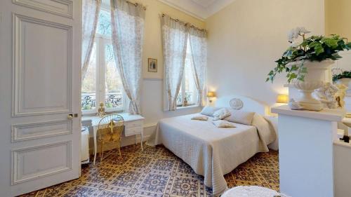 a bedroom with a bed and a window at Château "Le Castel des Anges" in Wailly-Beaucamp