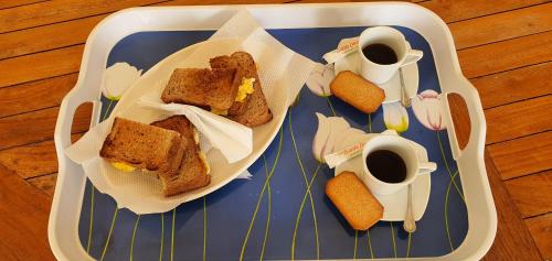 a tray with two sandwiches and two cups of coffee at Casa Giò in Las Terrenas
