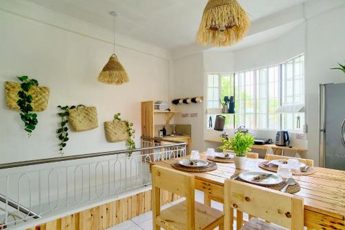 a kitchen with a wooden table and chairs in a room at Pallet Homes - Landheights Tropics in Iloilo City