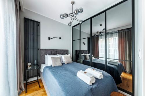 1 dormitorio con 2 toallas blancas en una cama azul en Apartament Active Residence, en Lublin
