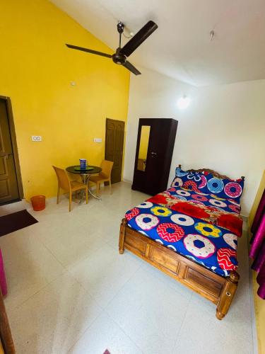 a bedroom with a bed and a table in it at Best Mist in Idukki