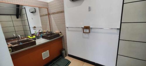 a kitchen with a white refrigerator and a sink at La ch'tite montagne in Cilaos