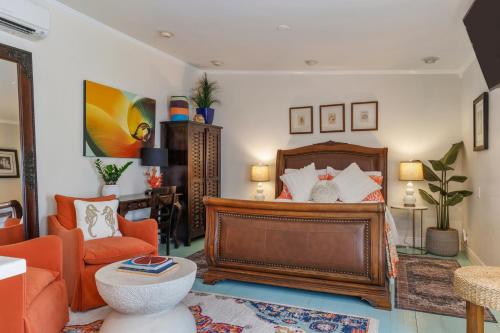 a bedroom with a bed and a living room at Studio Blue in Key West