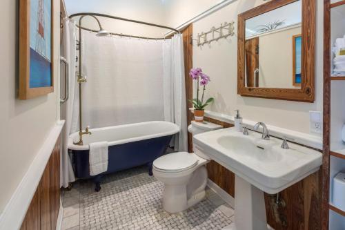 a bathroom with a sink and a tub and a toilet at Studio Blue in Key West
