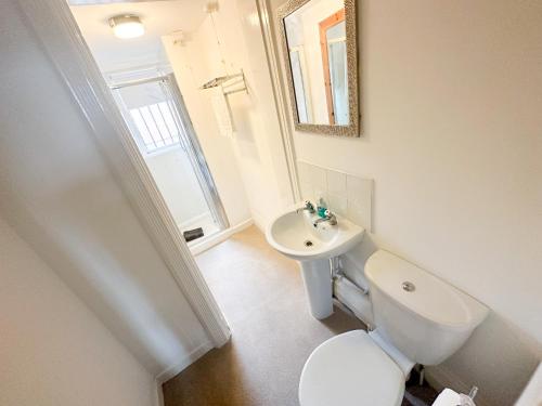 a bathroom with a white toilet and a sink at The Valley Inn Liverpool in Liverpool