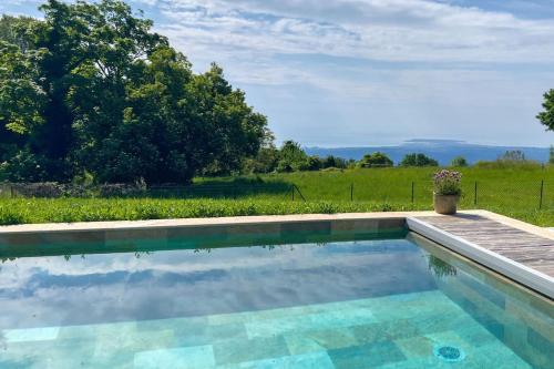 a swimming pool with a view of a field at Mas provençal avec piscine in Tourrettes-sur-Loup