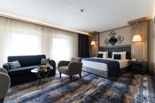 a hotel room with a bed and a couch at Ankara Plaza Hotel in Ankara