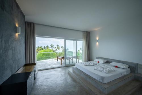 a bedroom with a large bed and a large window at OceanView Villa Manzini with Private Pool ZanzibarHouses in Kiwengwa