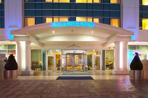 a hotel entrance with a sign that reads angle plaza hotel at Ankara Plaza Hotel in Ankara