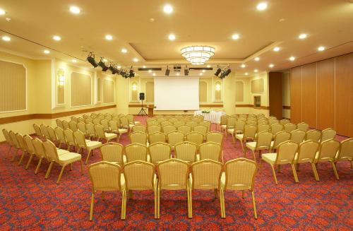a room with rows of chairs and a white screen at Ankara Plaza Hotel in Ankara